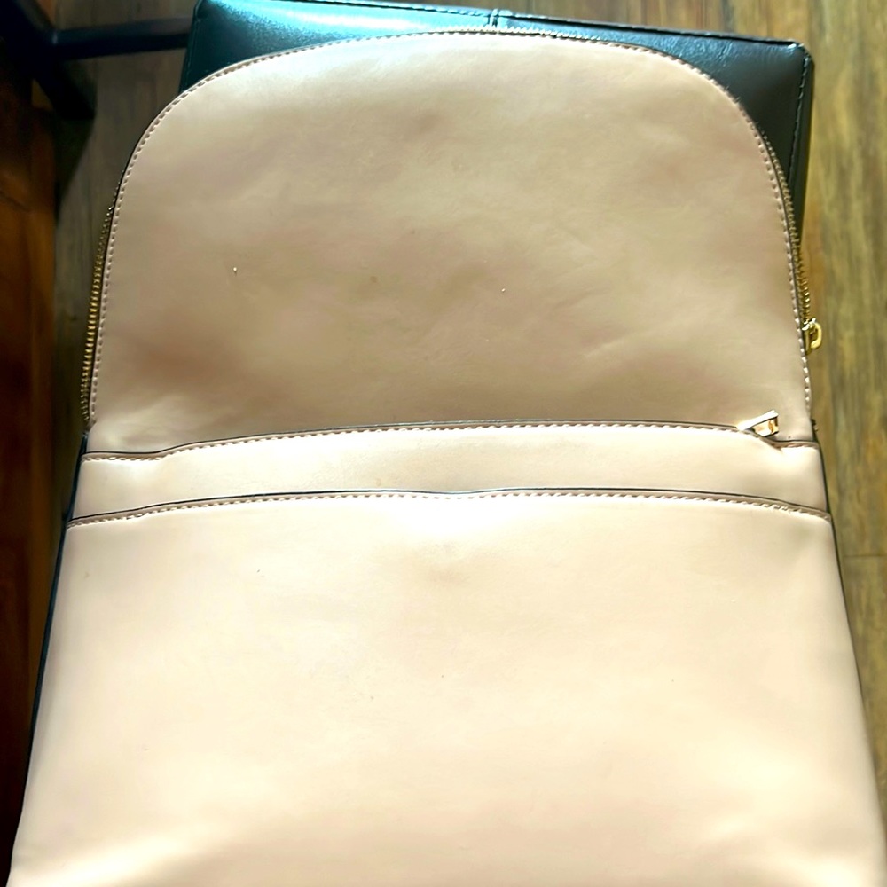 A cream sort of color brand is a new day and is pretty big can fit MacBook